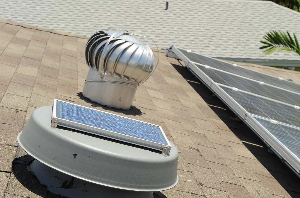A house equipped with a solar panel on its roof.