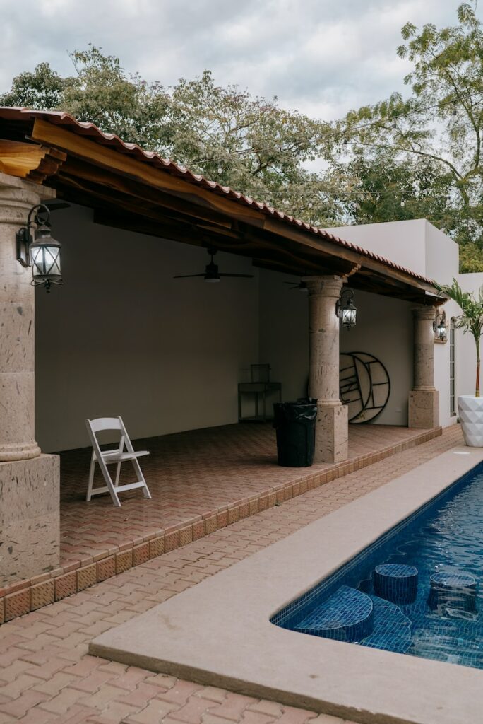 a patio with a pool and a covered patio
